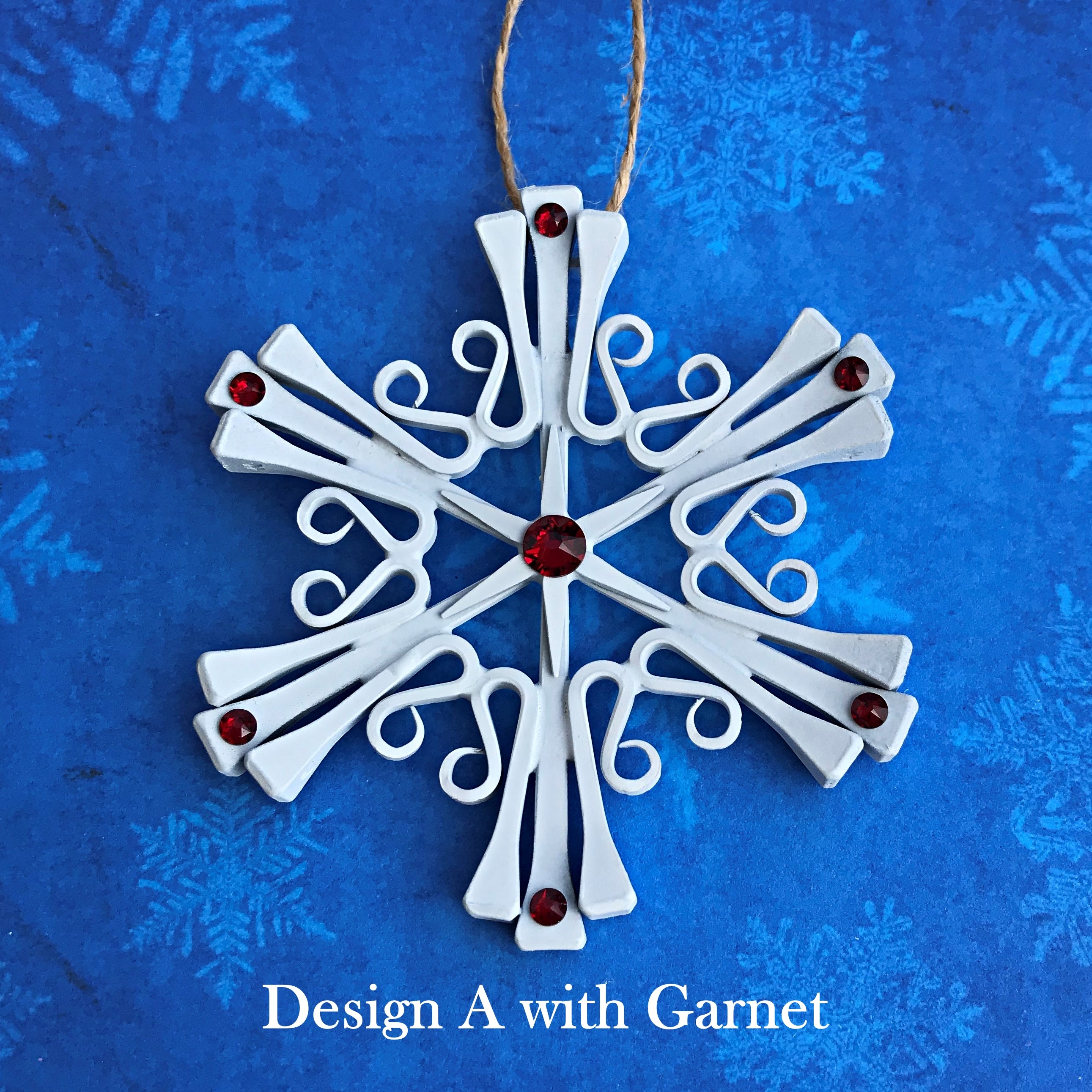 horseshoe nail snowflake ornament painted white with January Garnet Crystals