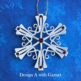 horseshoe nail snowflake ornament painted white with January Garnet Crystals